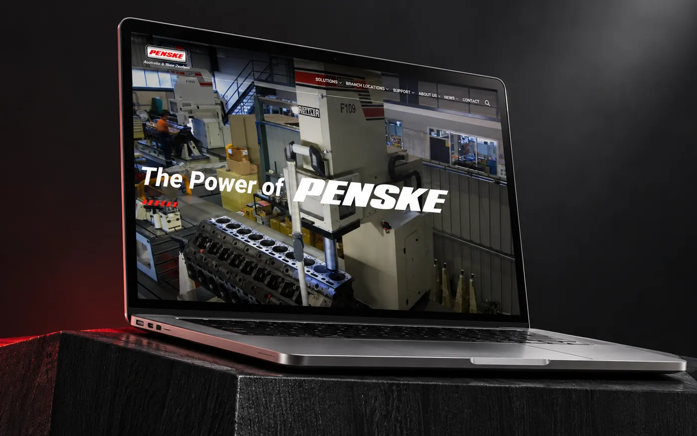 The Penske ANZ website on a laptop in an industrial setting