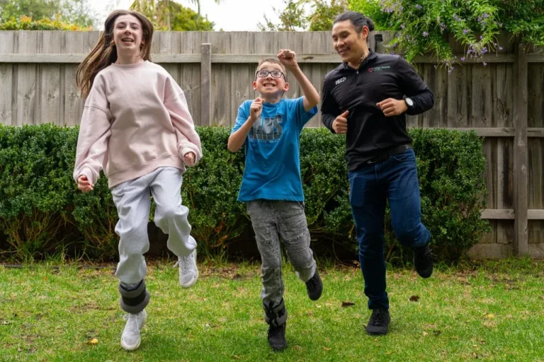 A Total Health Choice clinician with two children outdoors
